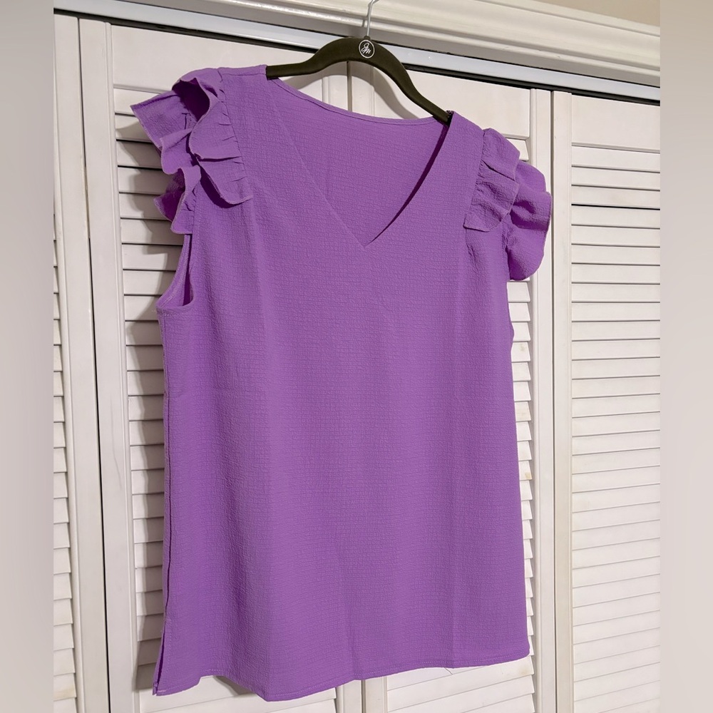 Cute purple top. Never worn, no tags.